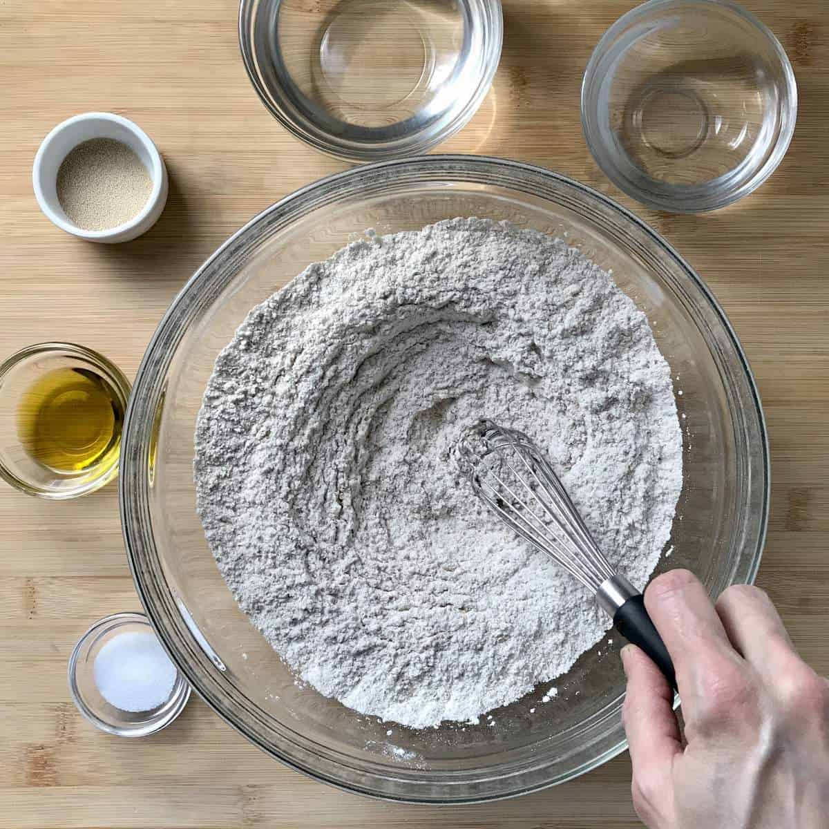Whole wheat flour being whisked in a bowl.