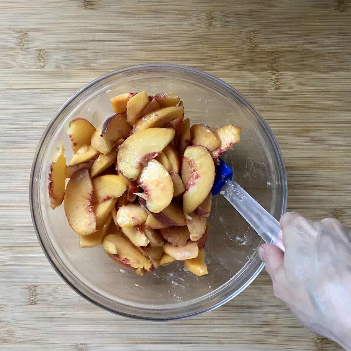 Sliced peaches in a bowl.