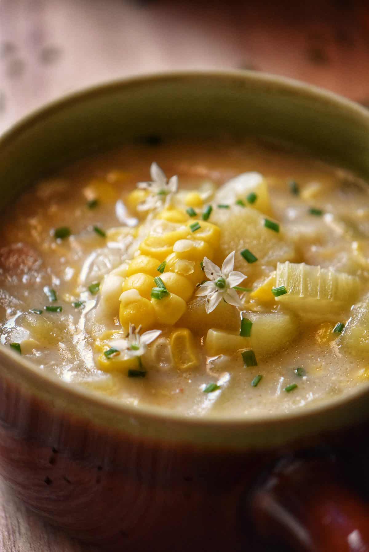A closeup of a bowl of sweet corn chowder. 