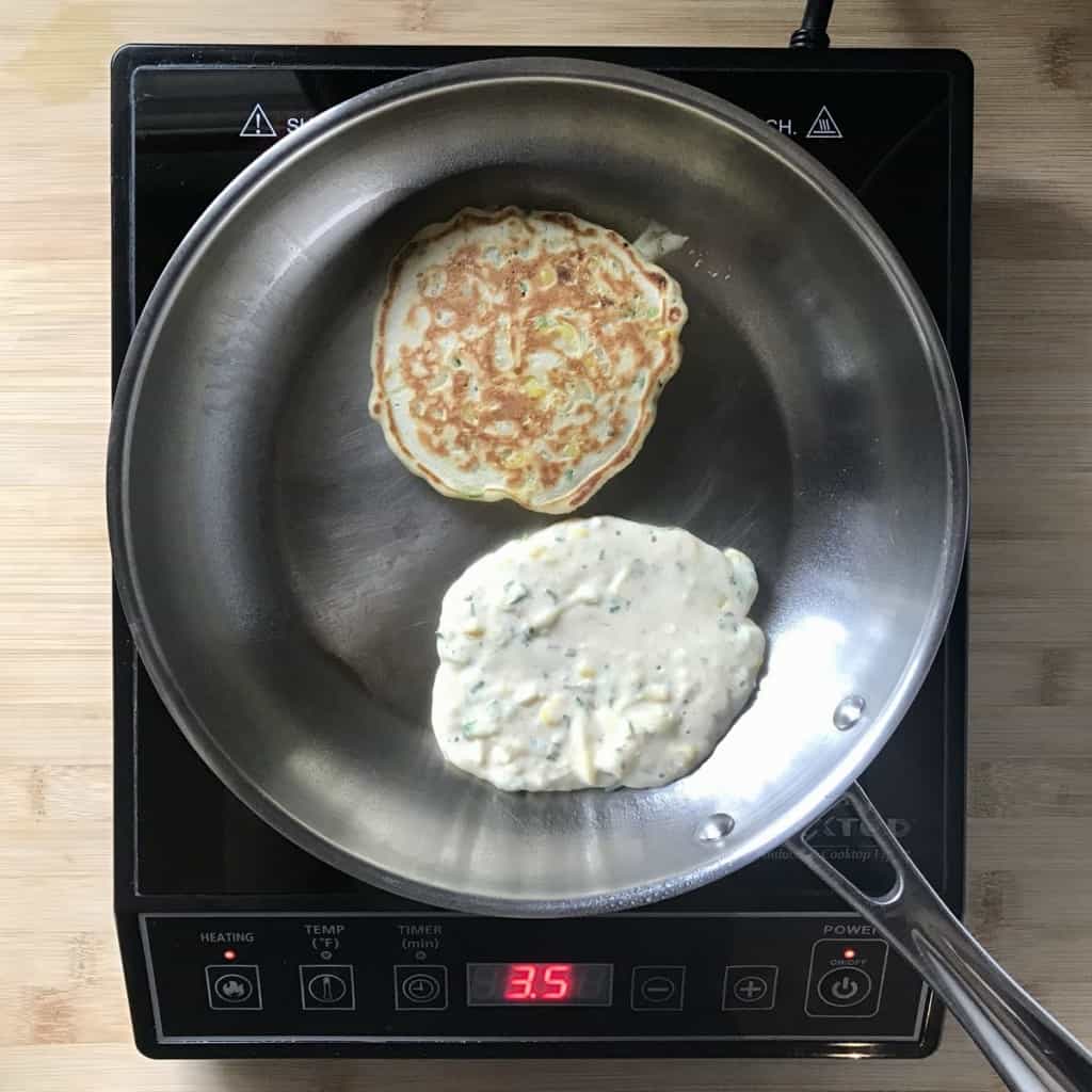 Zucchini pancakes in a pan.