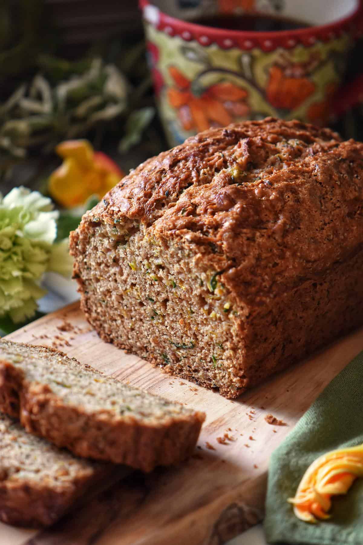 Zucchini loaf cut into slices on a cutting board.