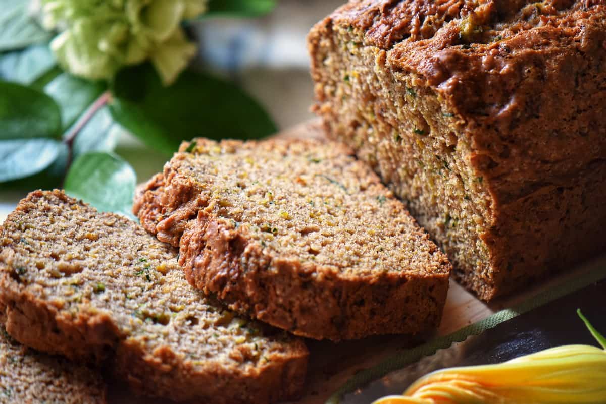 A close up of the tender crumb of a slice of healthy zucchini bread.