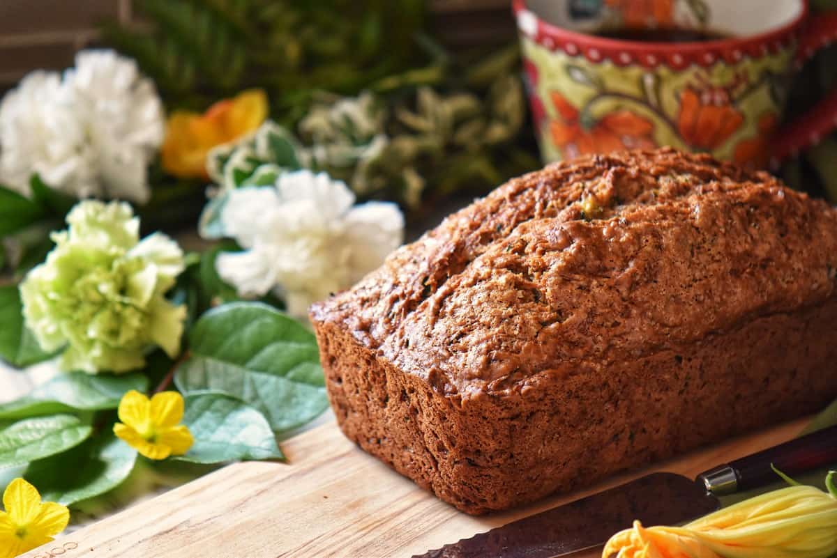 A baked zucchini loaf on a cutting board.