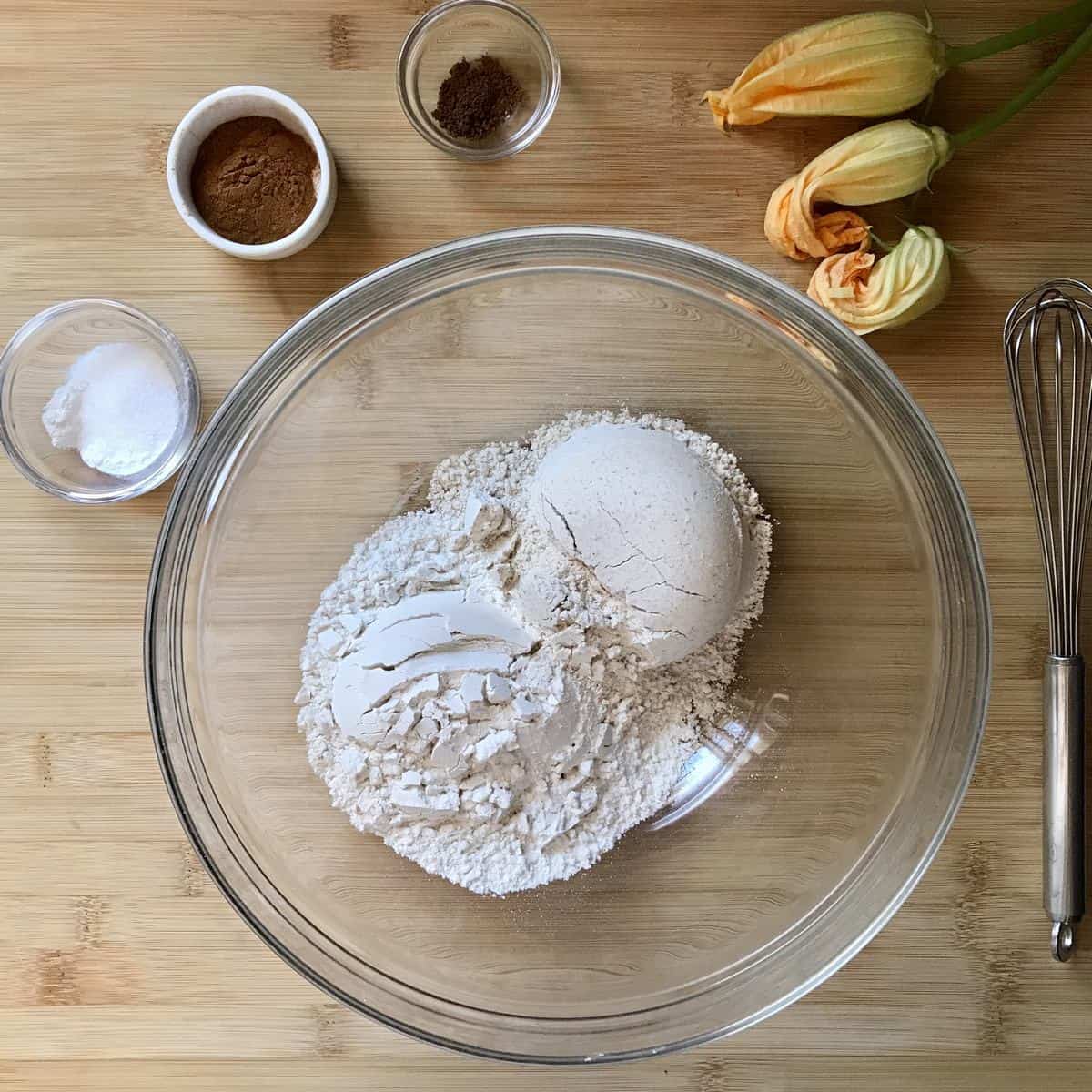 The dry ingredients to make a healthy zucchini bread recipe in bowls.