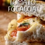A stack of sliced focaccia bread with cherry tomatoes.