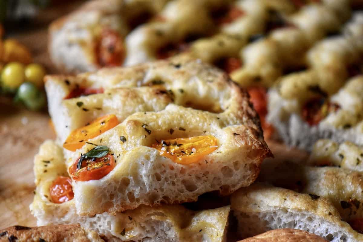 A close up of the roasted cherry tomatoes on the focaccia. 