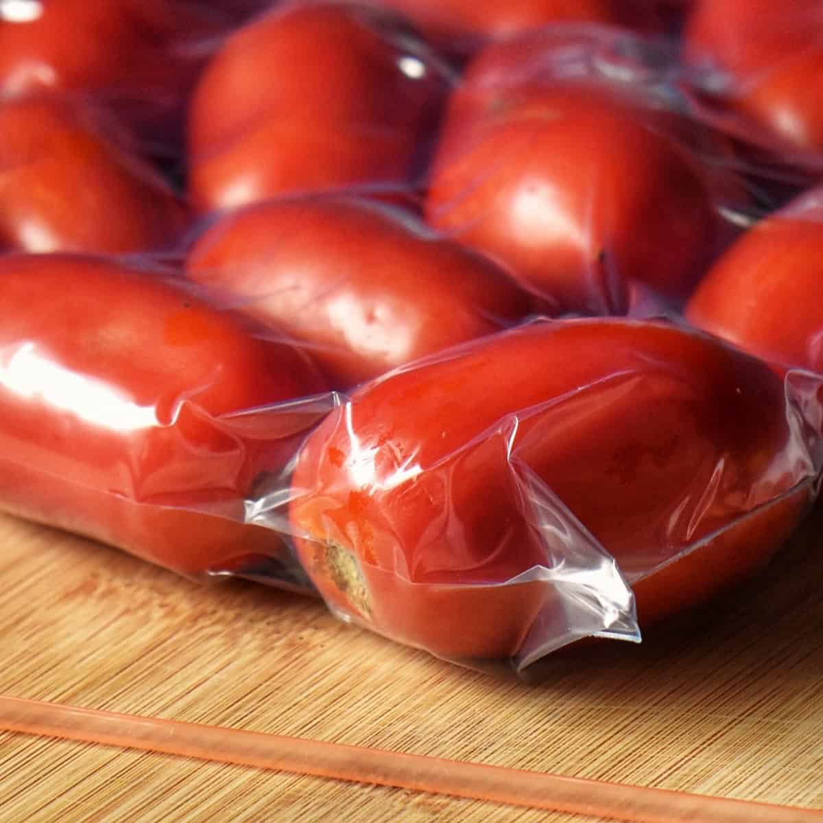 Frozen whole tomatoes in a freezer bag.