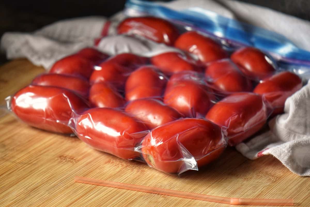 Roma tomatoes in a zip lock bag, ready to be frozen.