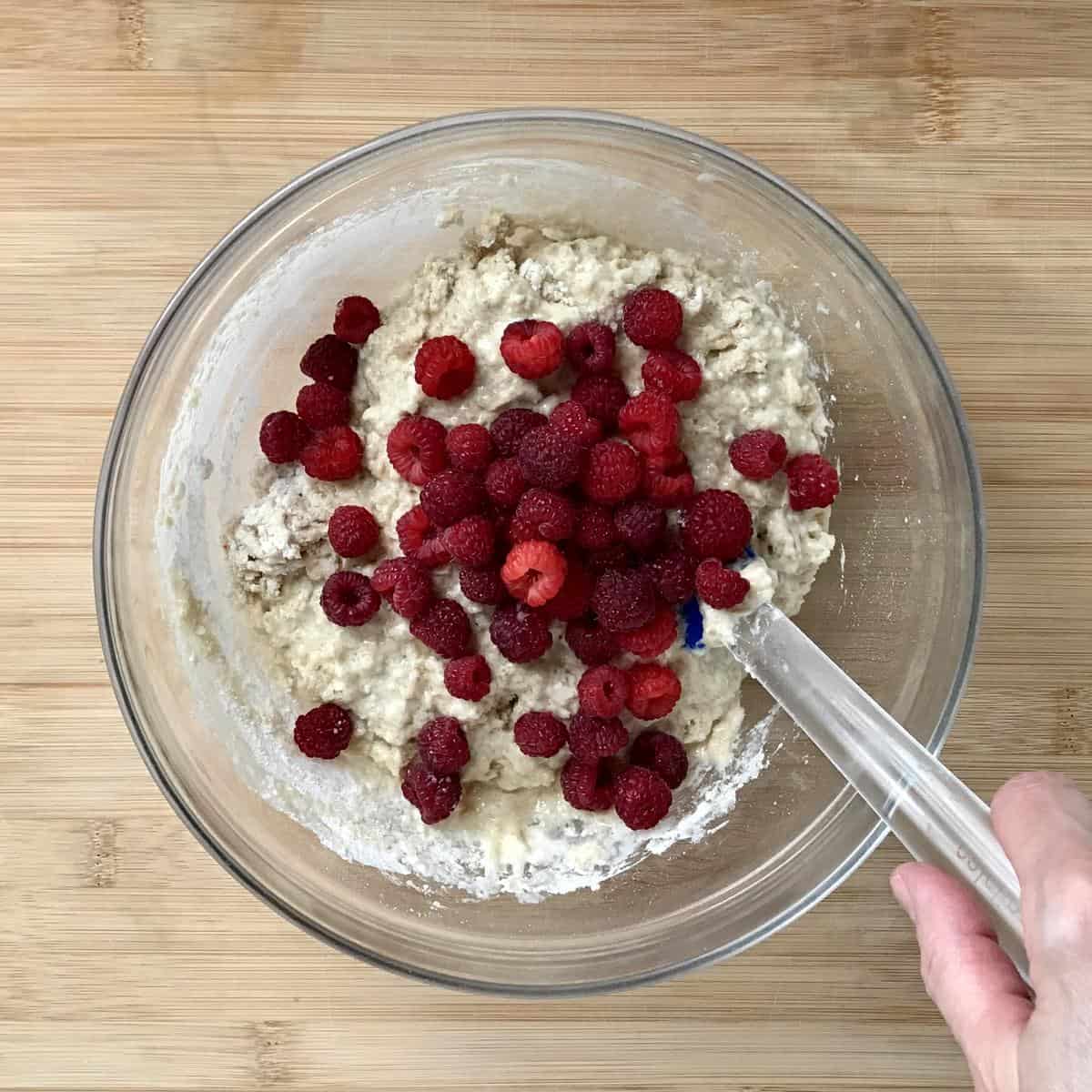 Raspberries being incorporated in the batter.