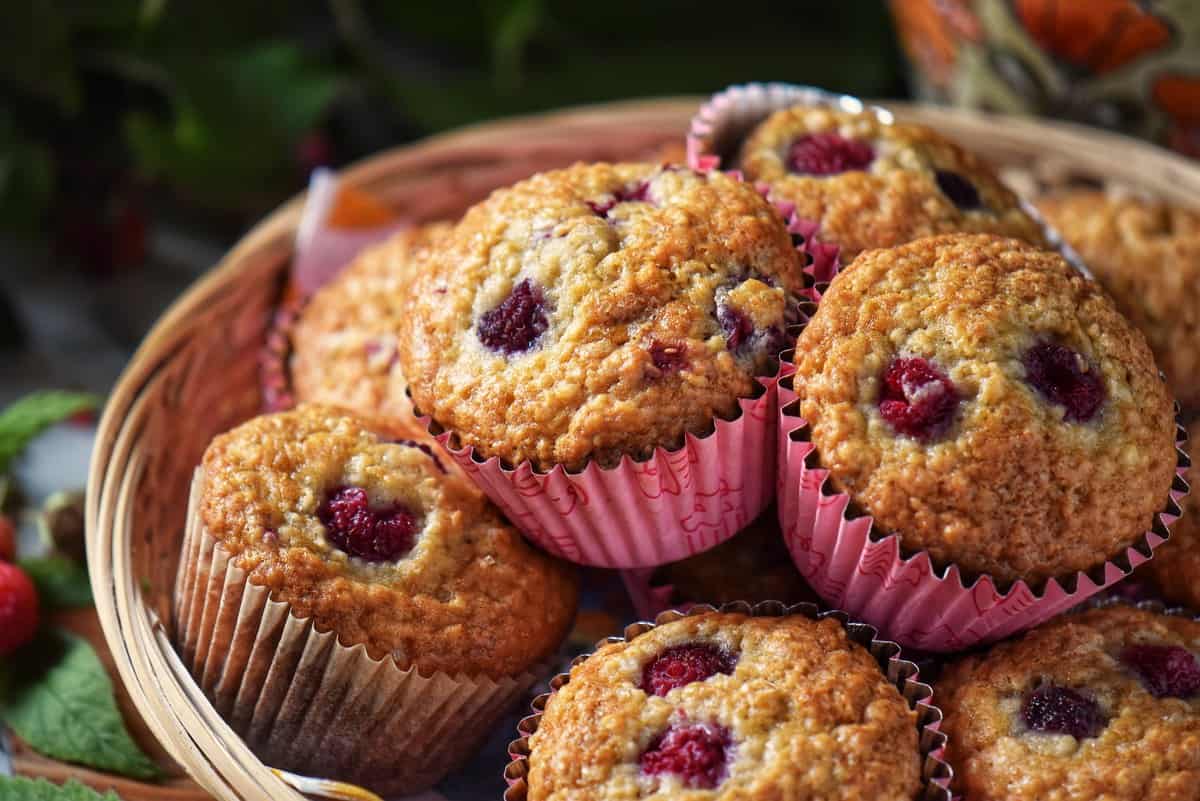 A close up photo of fruit muffins in a basket. 