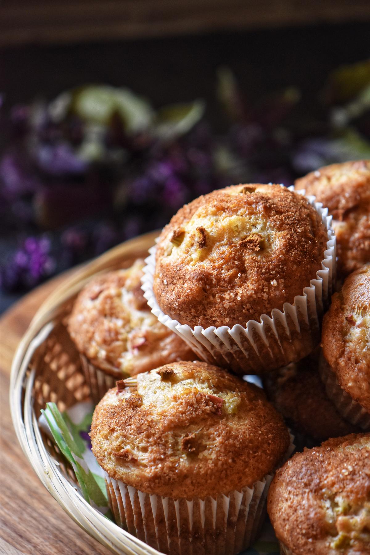 A pile of rhubarb muffins in a wicker basket.