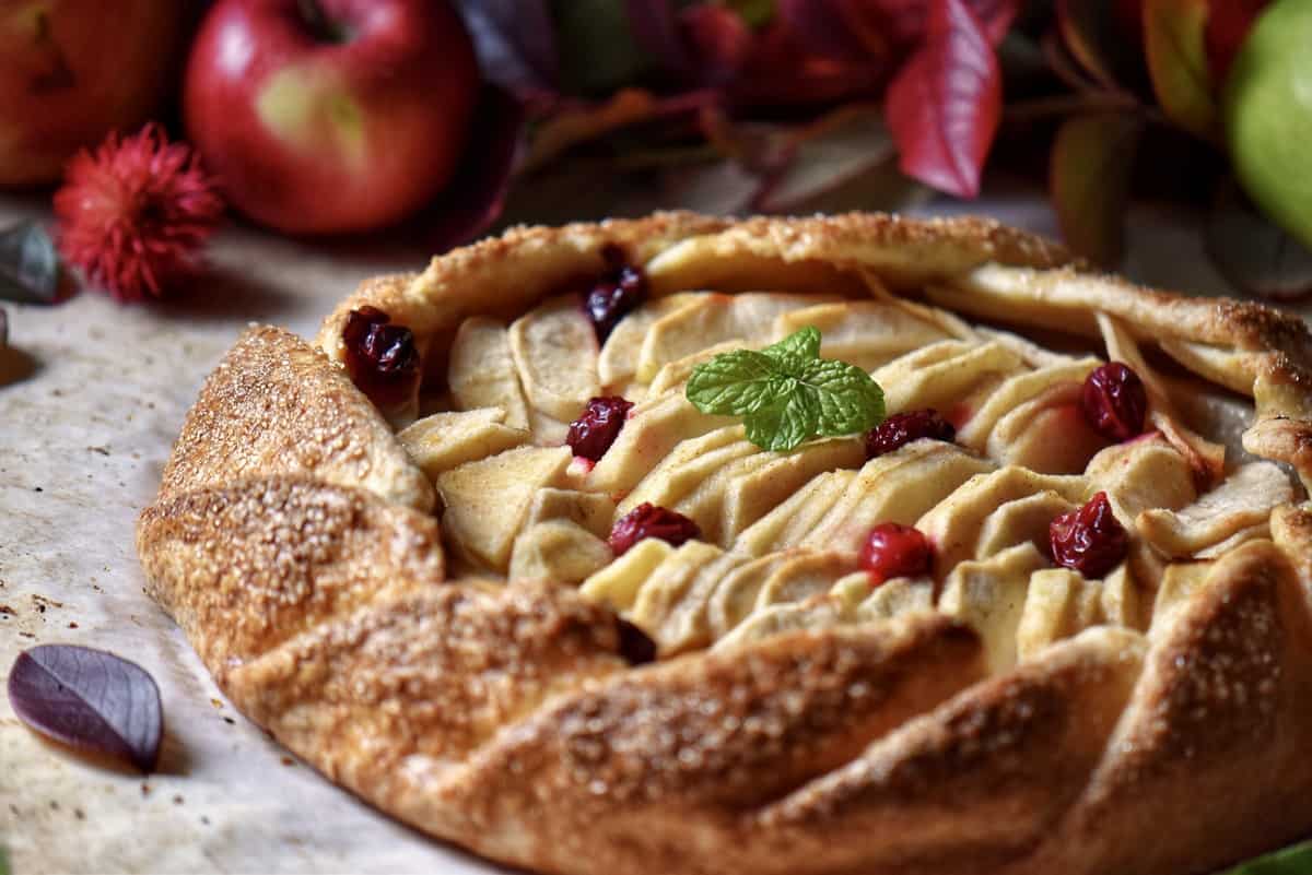 Apple crostata topped with cranberries. 