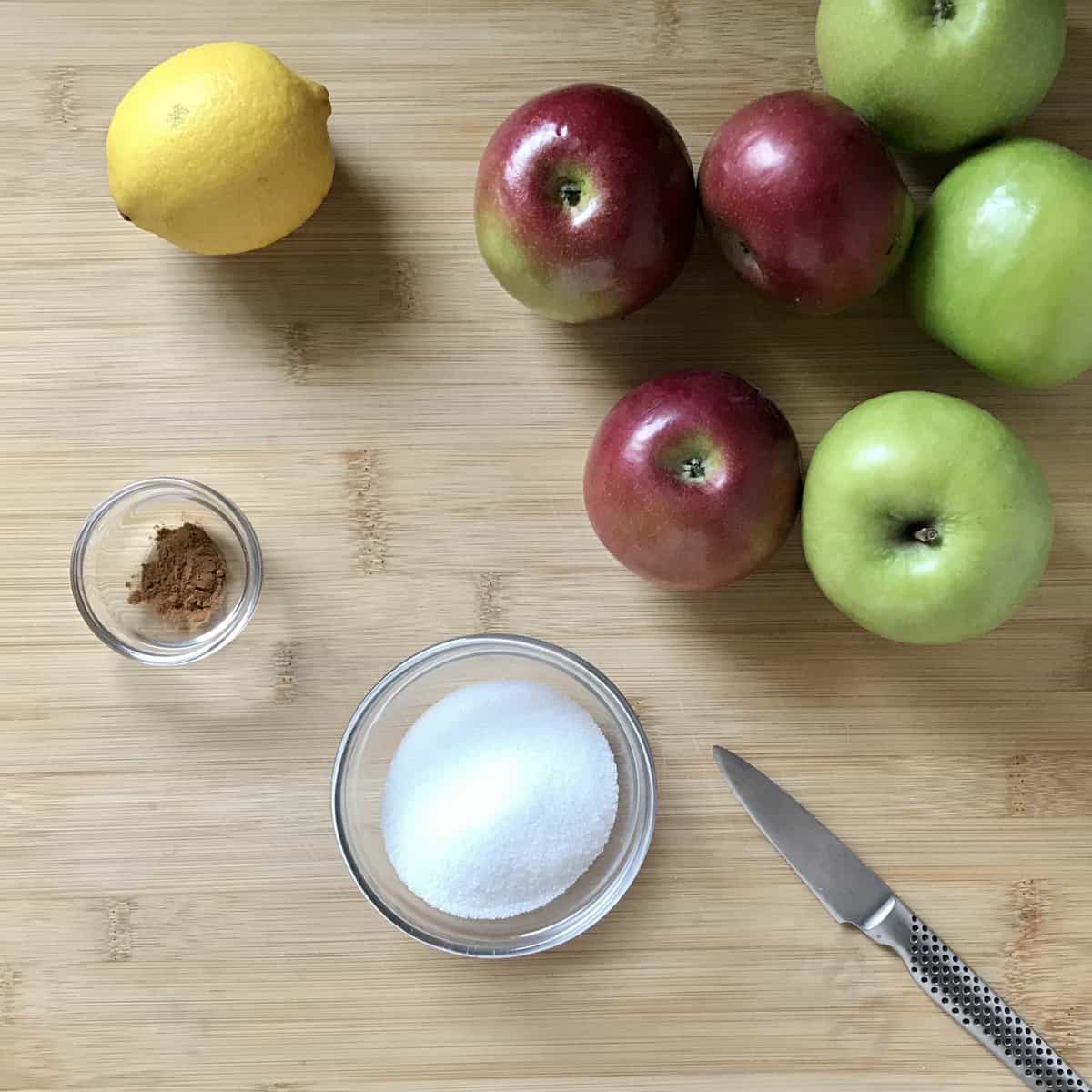 Ingredients used for the apple filling on a wooden board. 