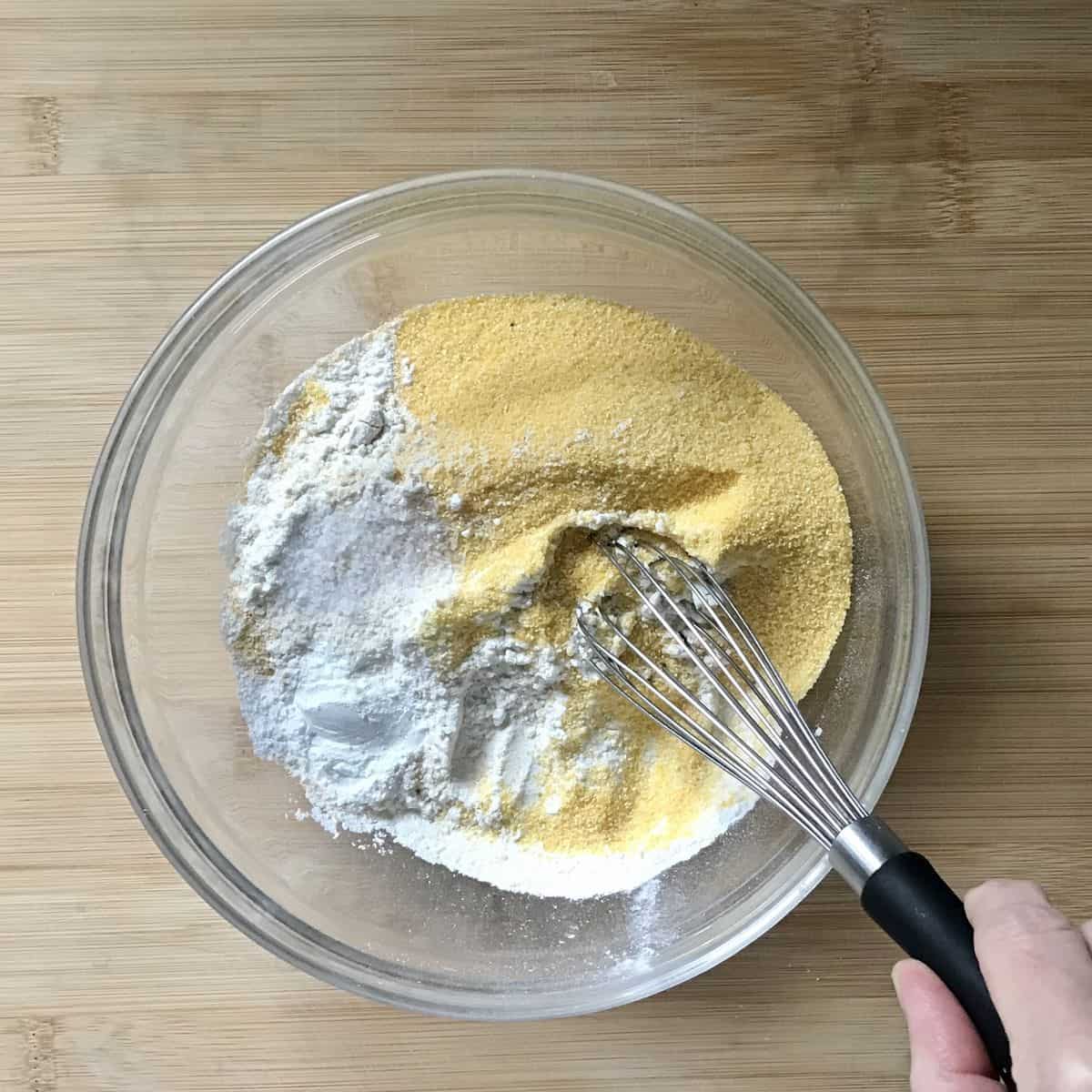 Dry ingredients being whisked together in a bowl.