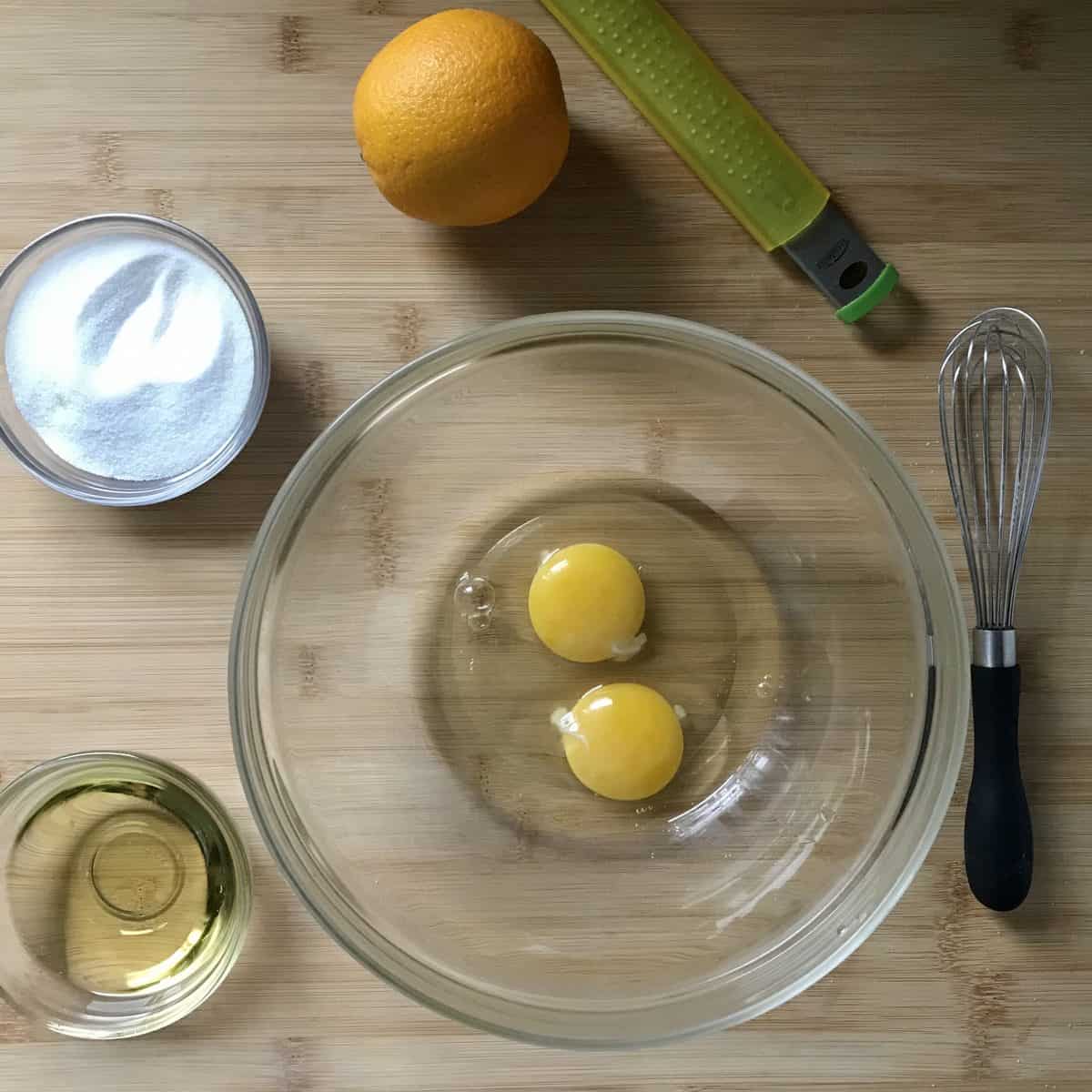 The liquid ingredients, in bowls, on a wooden board. 