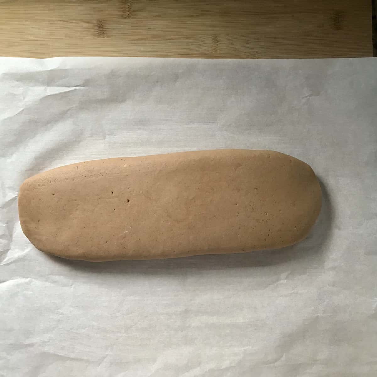 Biscotti log on parchment paper. 