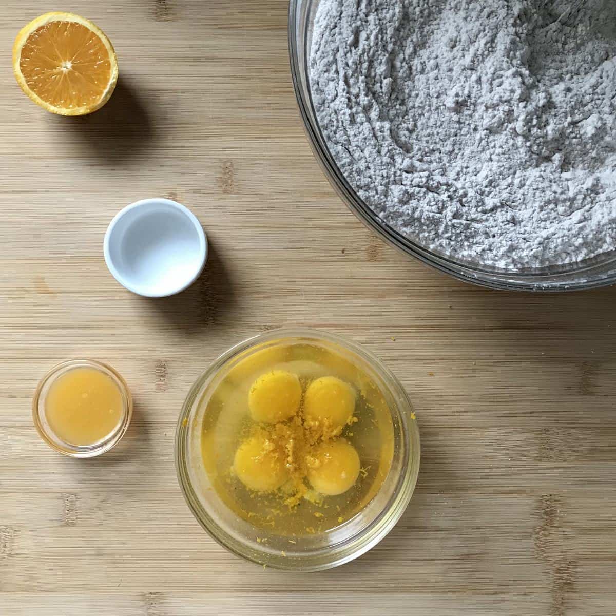 Wet ingredients to make biscotti on a wooden board. 