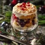 Zuppa Inglese in a glass topped with whipped ricotta on a silver platter.