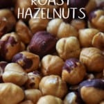 Roasted hazelnuts on a baking sheet.