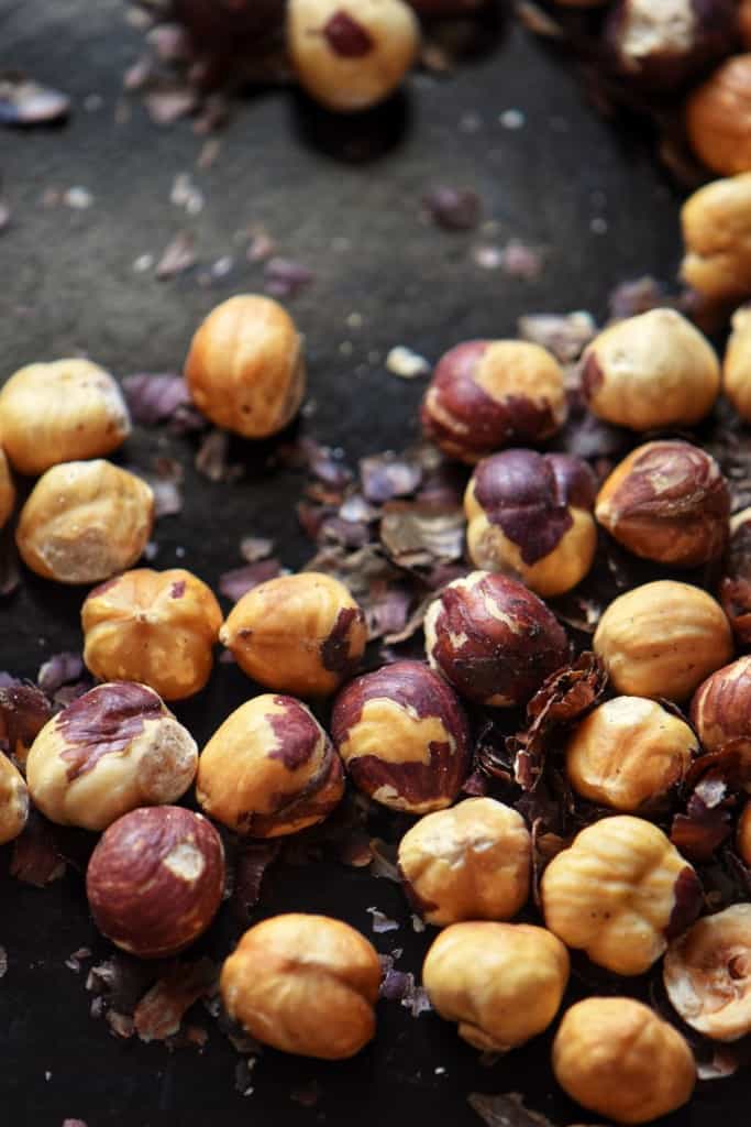 Skinned and roasted hazelnuts on a baking sheet.