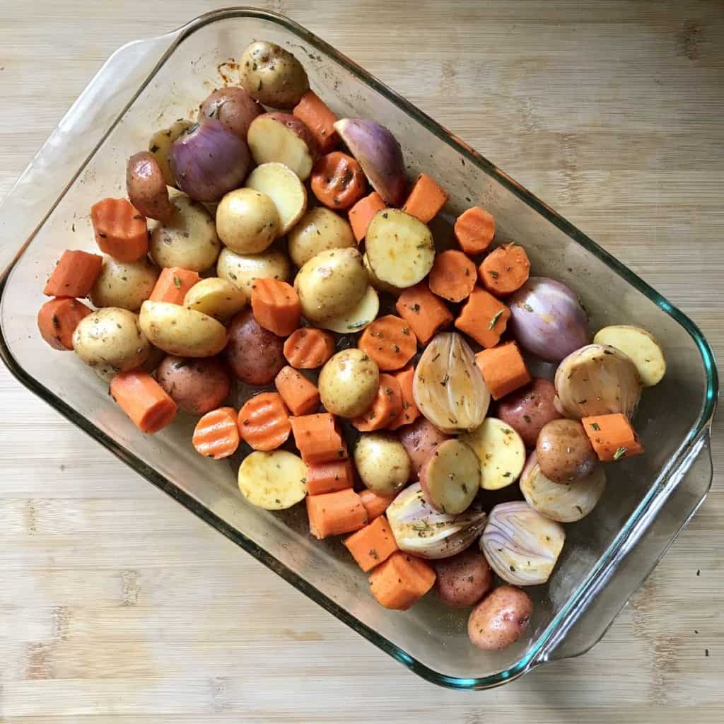 A baking dish of roasted small potatoes and carrots. .