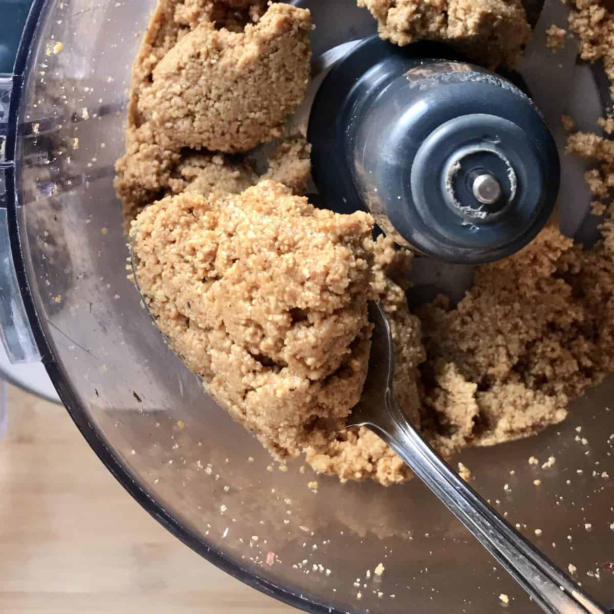 Clumps of nut butter in a food processor. 