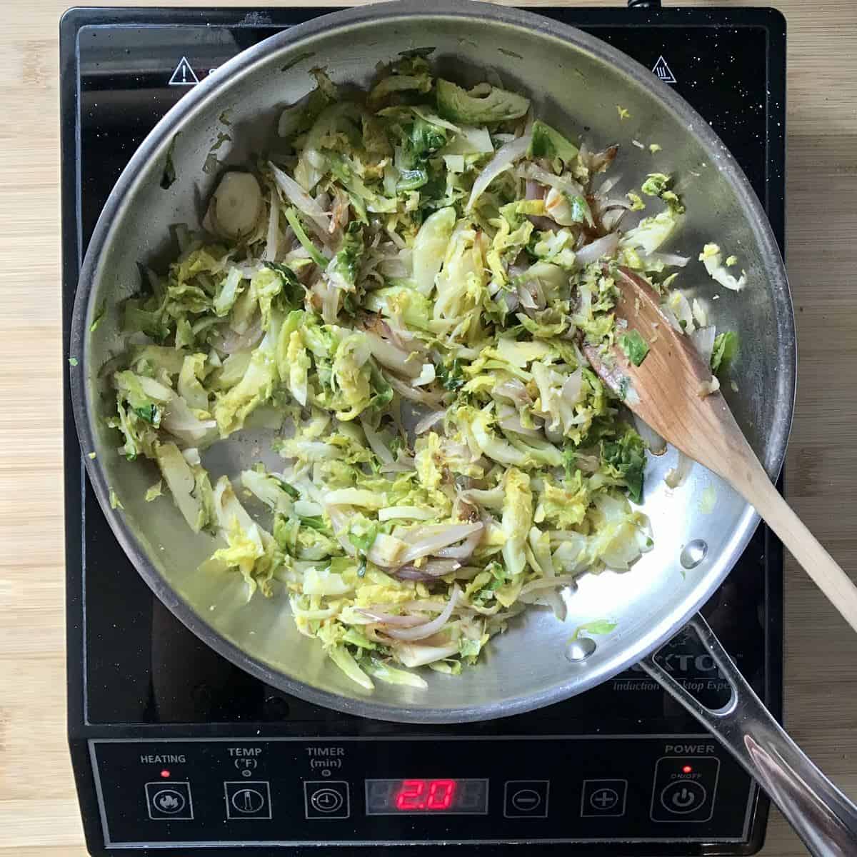 Sauteed spouts and shallots in a pan. 