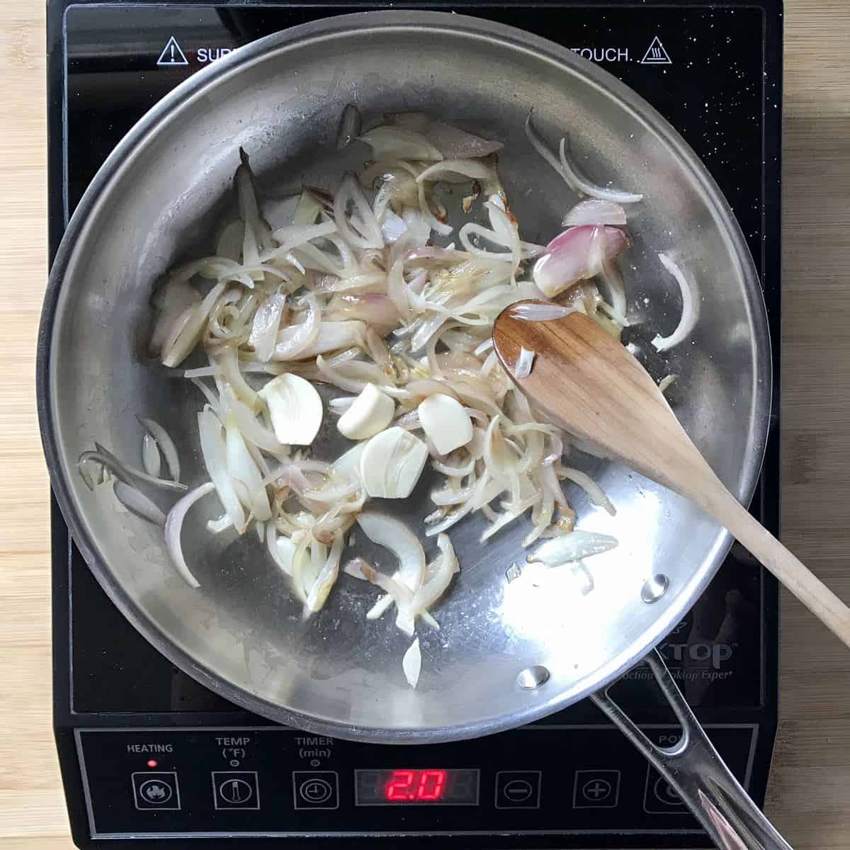 Shallots and garlic in a large saute pan.