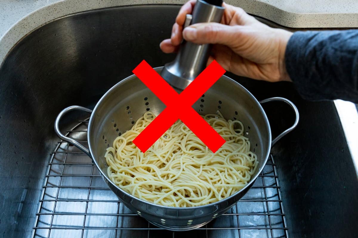 A red cross mark on rinsing drained pasta.