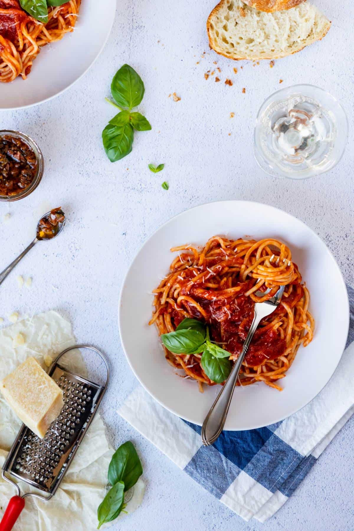 A table setting for a pasta dinner.