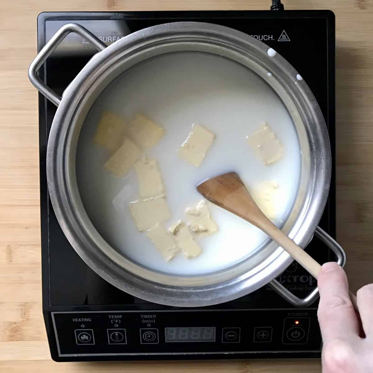 Milk, water and butter being heated in a small saucepan. 
