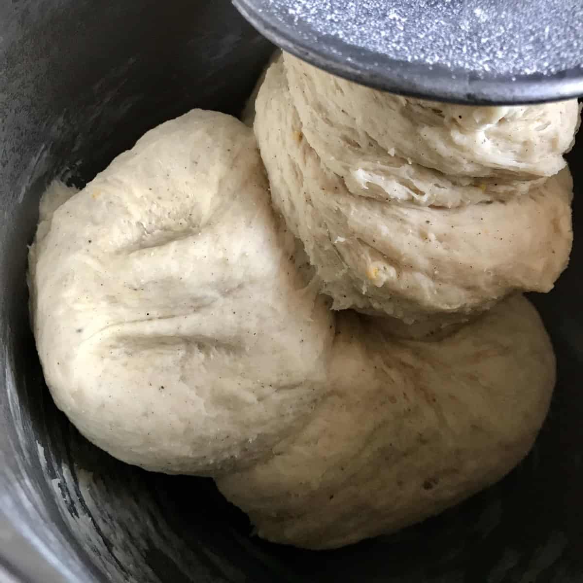 Sweet dough in the bowl of a stand mixer.