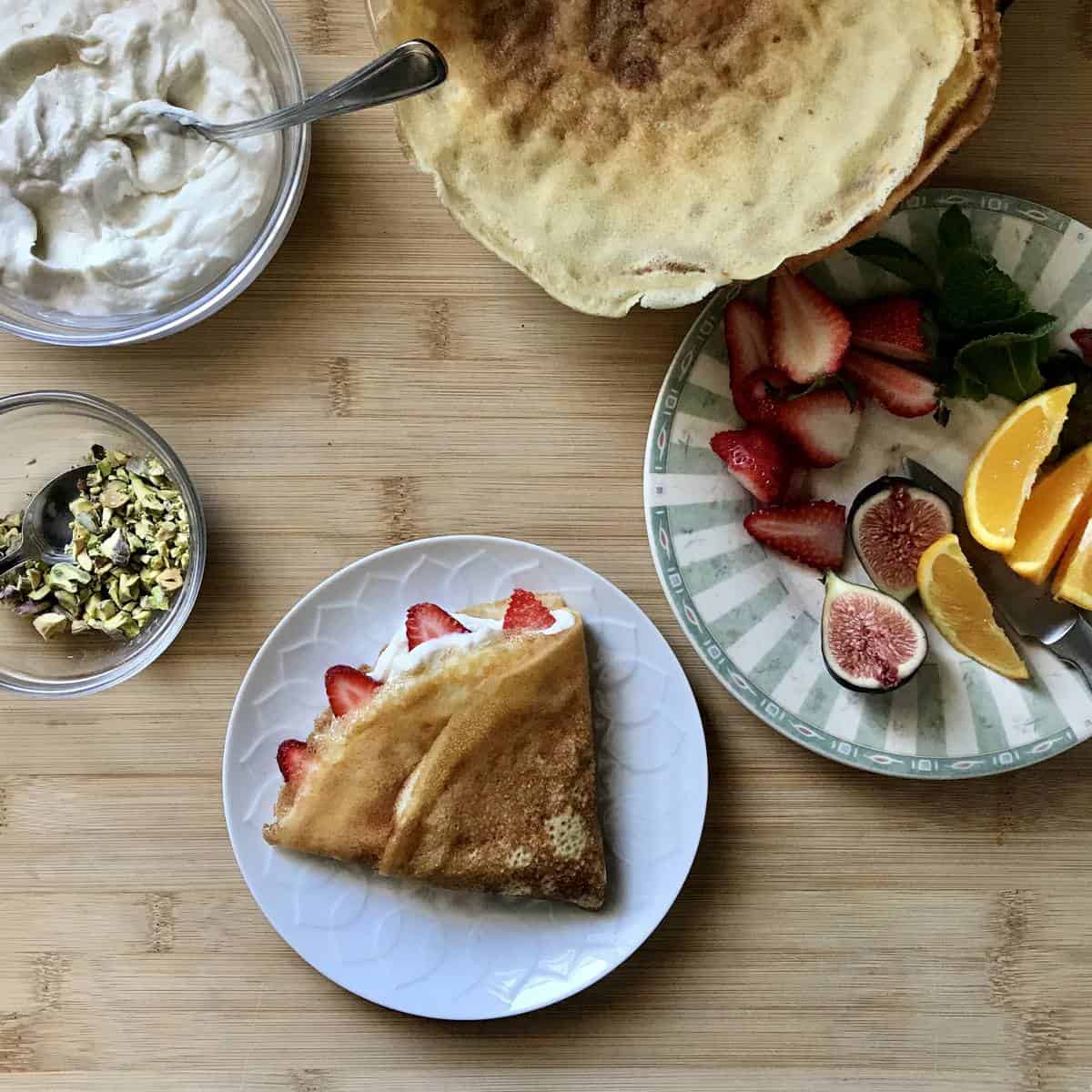 A ricotta filled crepe in a white plate.