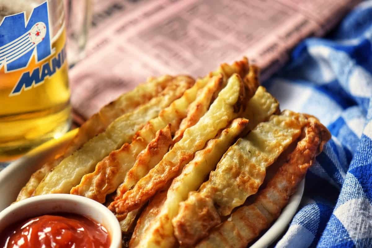 Crinkle cut fries with a small dish of ketchup.