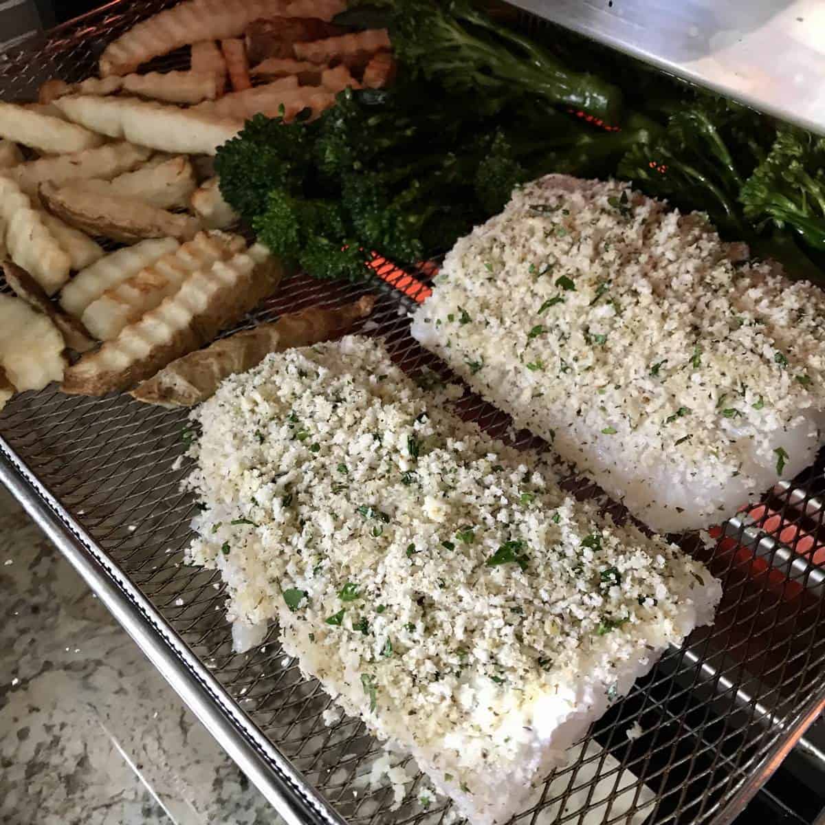 Air fryer cod on a Breville air fryer wire basket.