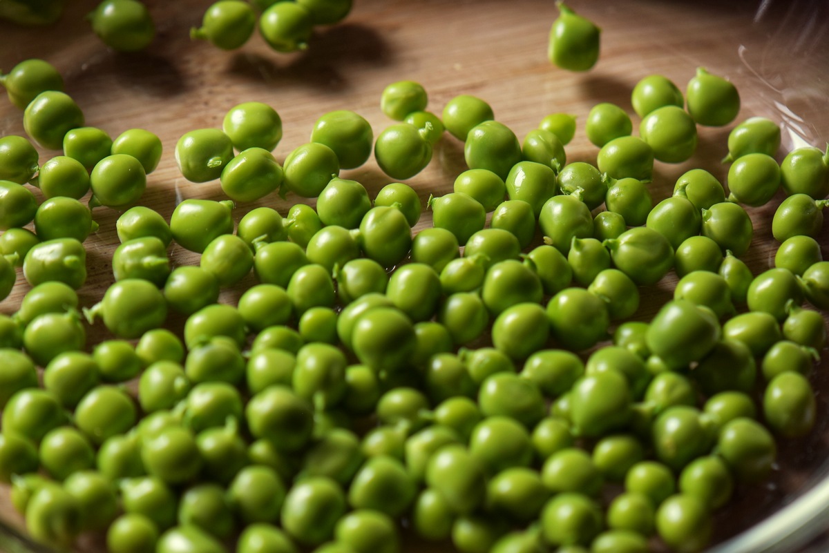 A close-up photo of freshly harvested garden peas.