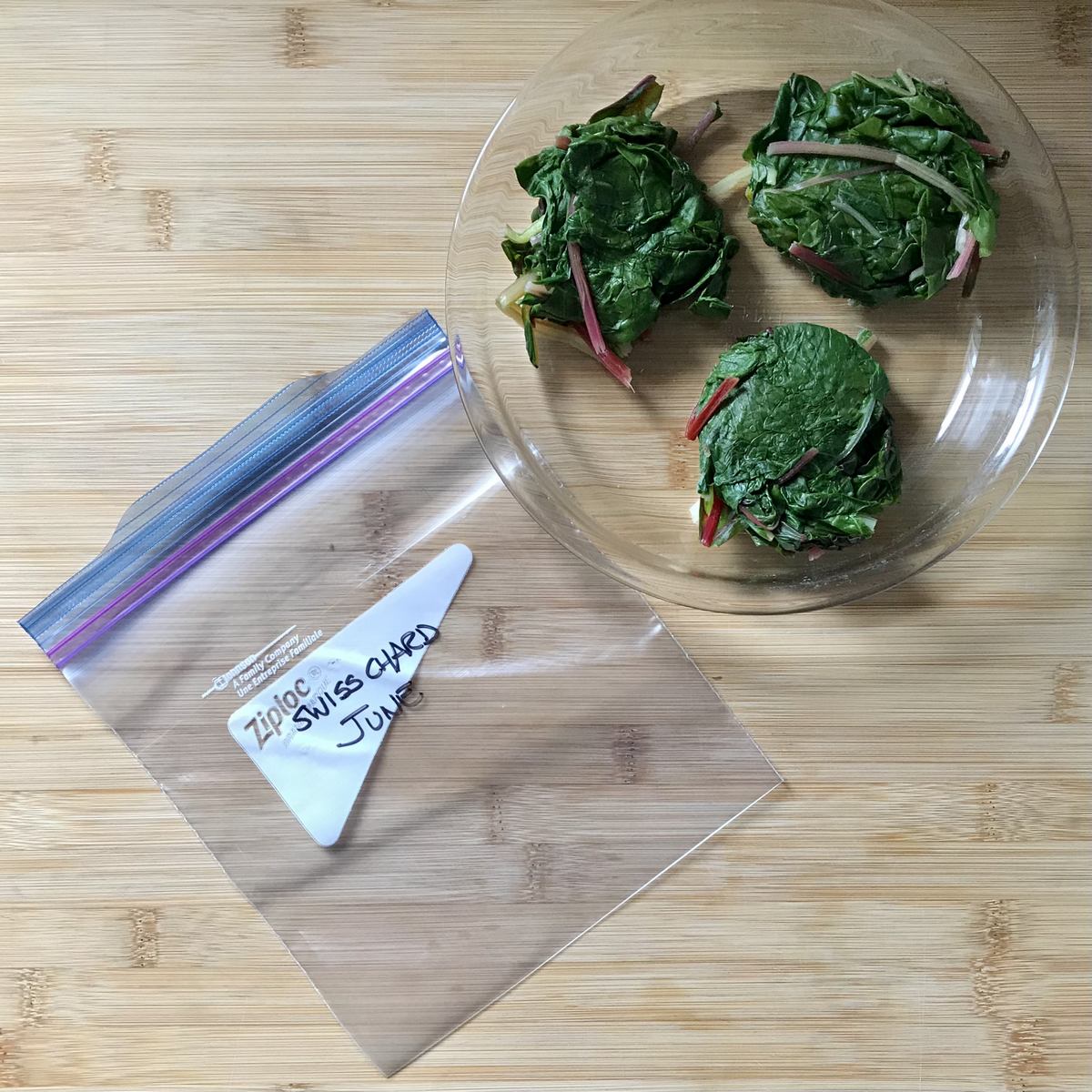 Small pucks of Swiss chard next to a Ziplock bag.