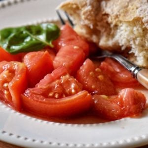 Chopped tomato salad in a white dish.