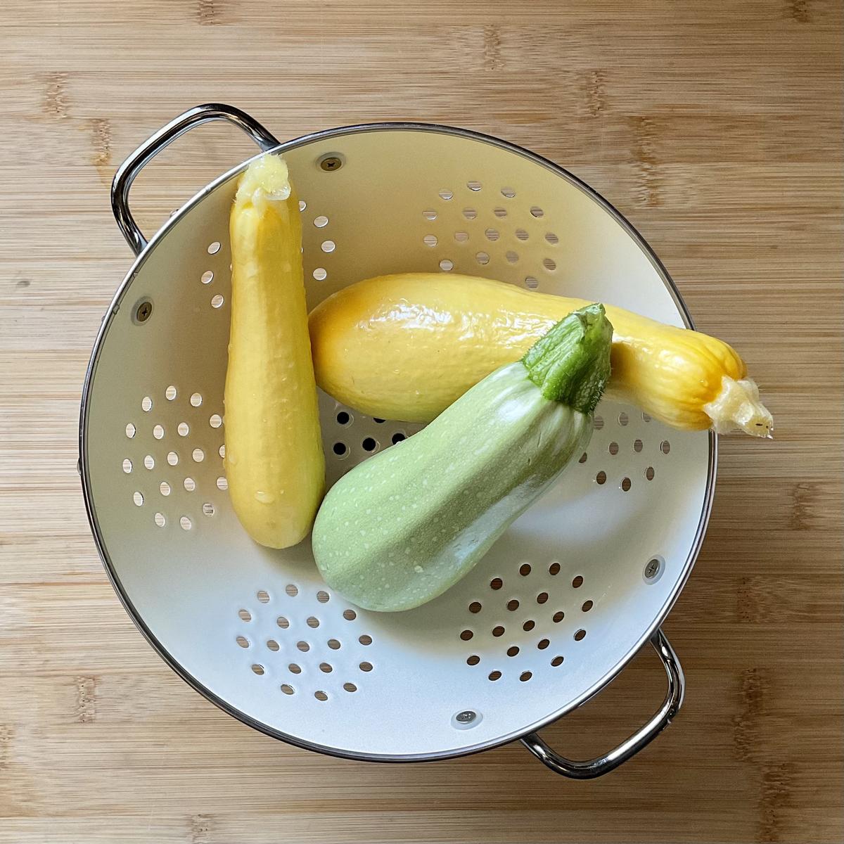 Yellow squash and zucchini in a colander. 
