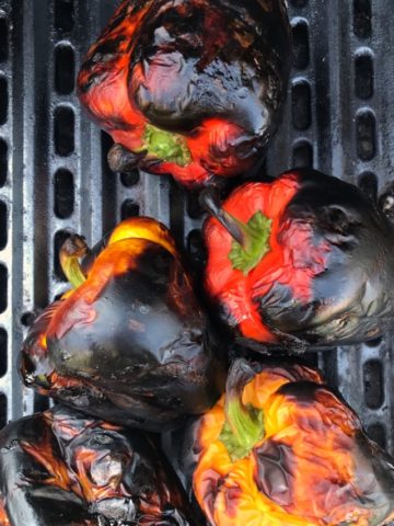 Roasting bell peppers on a grill.