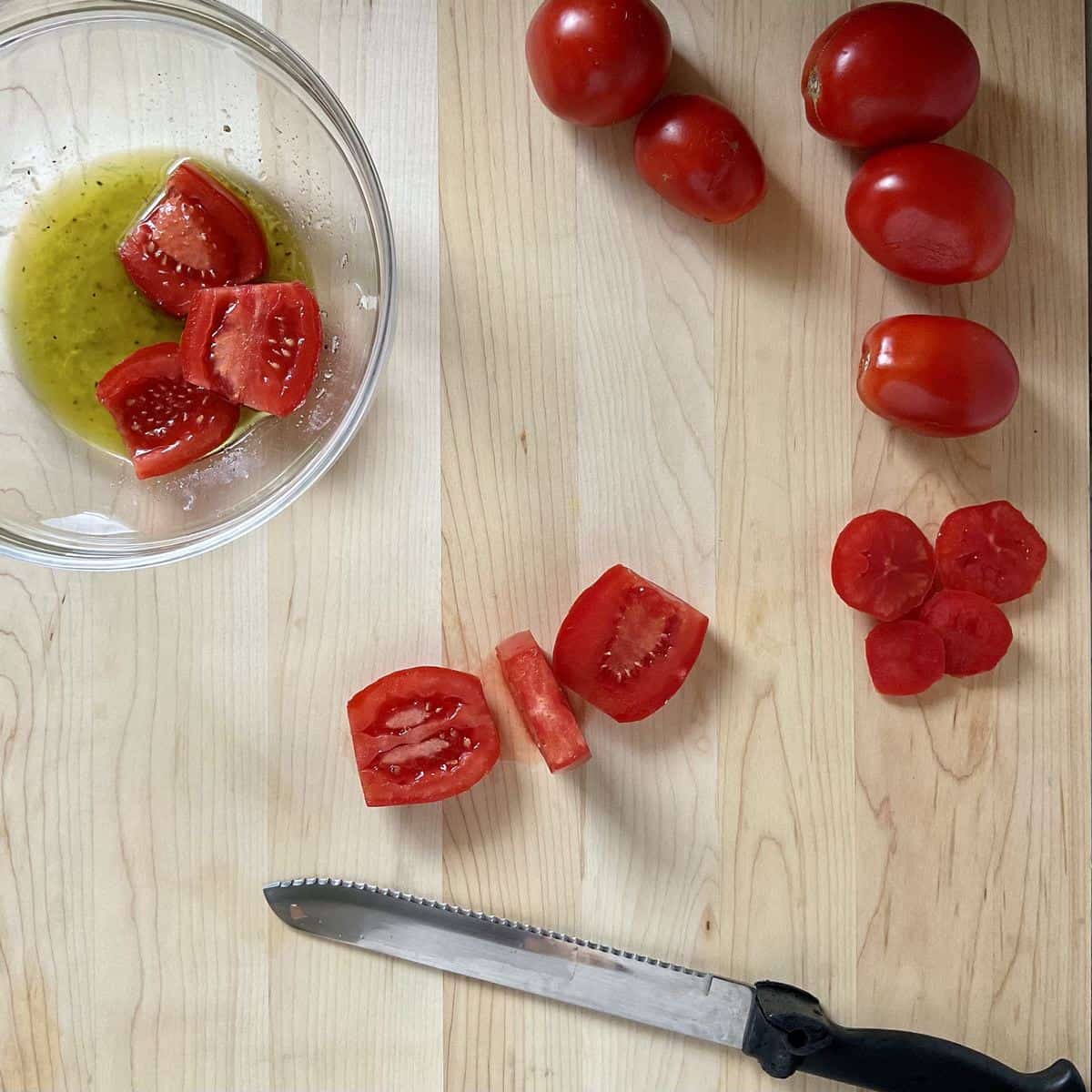 Sliced tomatoes on a wooden board.