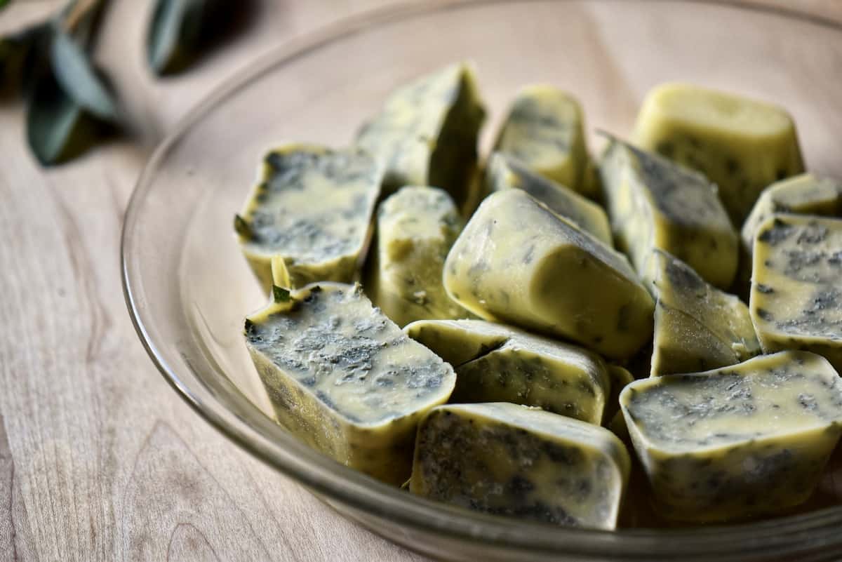 Frozen cubes of herbs on a dish.