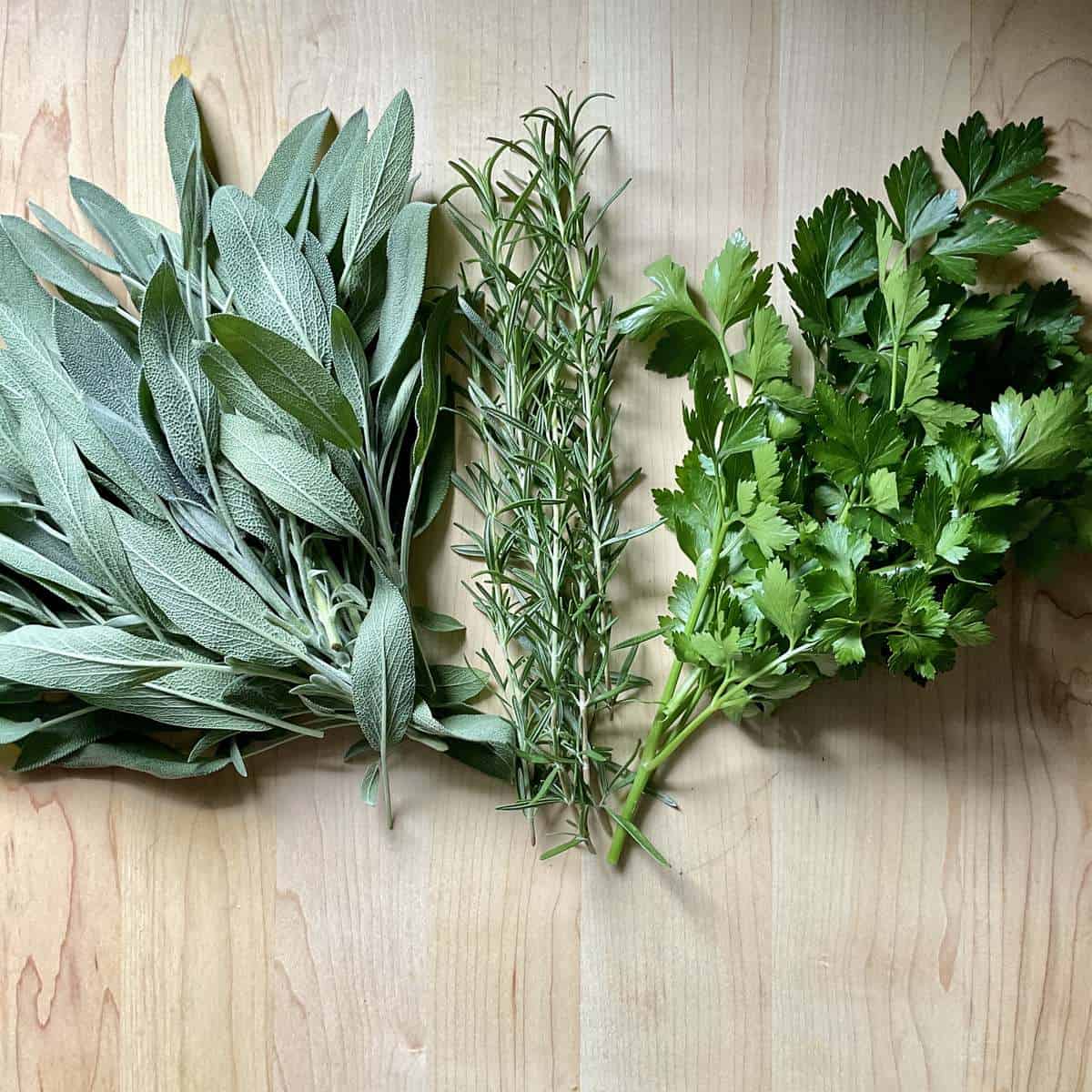 Fresh herbs on a wooden board.