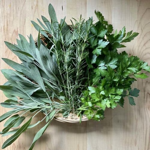 Fresh herbs on a wicker basket.