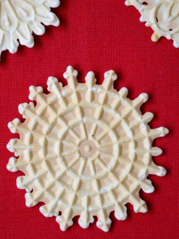Pizzelle on a red tablecloth.