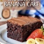 Chocolate Banana Cake on a white plate garnished with sliced bananas and strawberries.