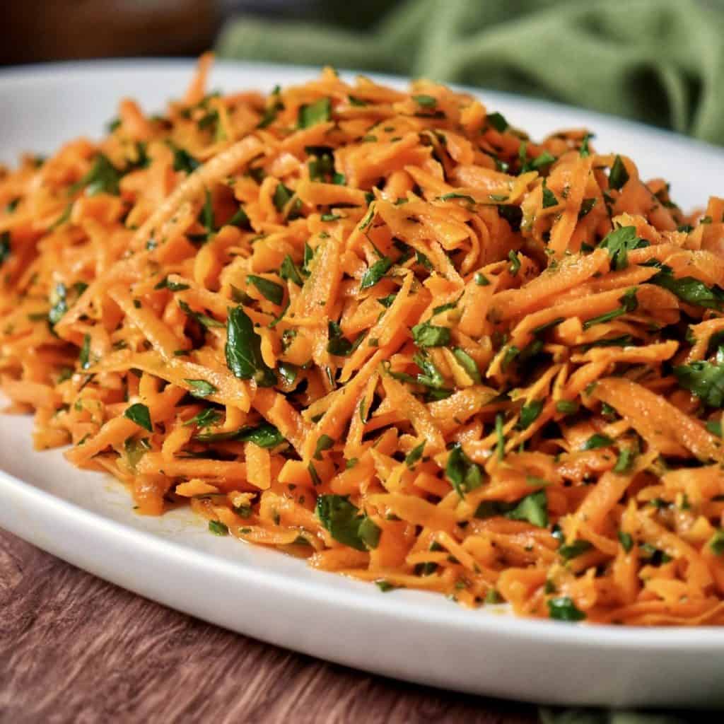 Carrot salad on a white serving platter.