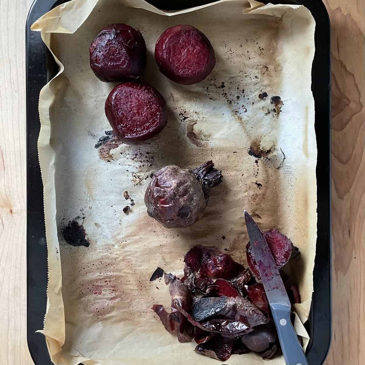 Peeled whole beets on parchment paper.