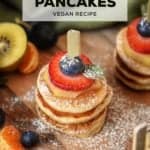 A stack of three mini pancakes with fruit.