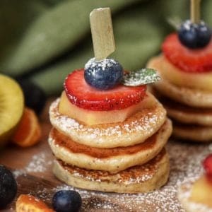 Mini pancakes help together with a wooden skewer.